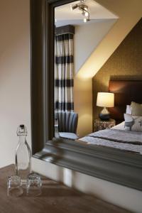 a bedroom with a large mirror and a bed at No12 Hotel in North Berwick
