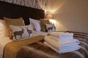 a bedroom with a bed with towels on it at No12 Hotel in North Berwick