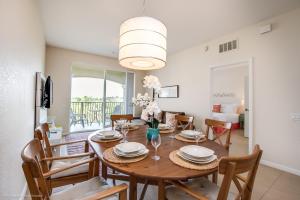 comedor y sala de estar con mesa y sillas en Cozy Condo wPrivate Balcony & FREE Resort Access en Orlando