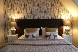 a bedroom with a large bed with two lamps at No12 Hotel in North Berwick