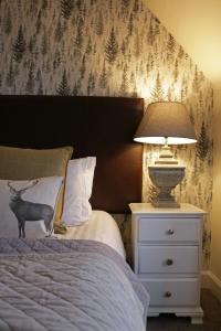 a bedroom with a bed with a lamp on a night stand at No12 Hotel in North Berwick