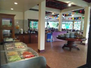 a buffet in a restaurant with a table with food at Holiday Villa, Lanta in Ko Lanta