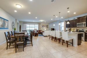 a dining room and kitchen with a table and chairs at Villa w Private Pool FREE Resort Access in Kissimmee