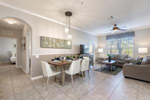 a dining room and living room with a table and chairs at Beautiful Vista Cay Condo, Near I-Drive in Orlando
