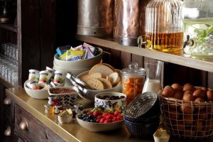 a shelf with bowls of food and other foods on it at Beadnell Towers Hotel in Beadnell +226 photos
