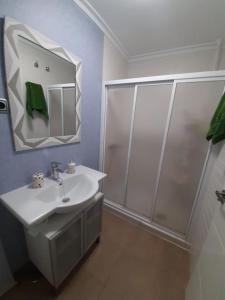 a bathroom with a white sink and a shower at House Parra in San Juan de los Terreros +54 photos