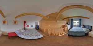 a large room with two beds and a crib at Cihlarka 303 in Černý Dŭl