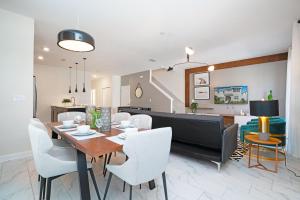 a dining room and living room with a table and chairs at Beautiful Modern Home wPrivate Pool Near WDW in Kissimmee