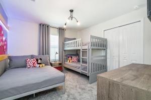 a bedroom with two bunk beds and a couch at Beautiful Modern Home wPrivate Pool Near WDW in Kissimmee +45 photos