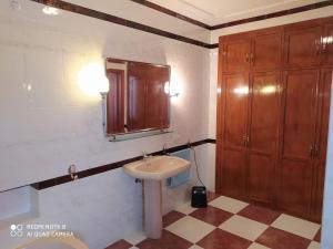 a bathroom with a sink and a mirror at La Casa del Montero in El Pedroso