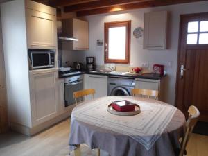 a kitchen with a table with a box on it at Chalet des Clarines in Saint-Genès-Champespe