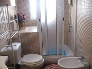 a bathroom with a toilet and a shower and a sink at Casa Santana in Nordeste +46 photos