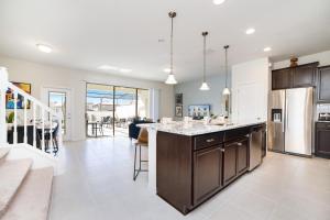 a kitchen with a large island and a dining room at Townhome Splash Pool BBQ FREE Water Park in Kissimmee