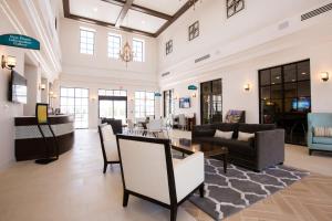 a lobby with couches and a table and chairs at Townhome Splash Pool BBQ FREE Water Park in Kissimmee