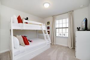 a bedroom with a white bunk bed with red pillows at Townhome Splash Pool BBQ FREE Water Park in Kissimmee +58 photos
