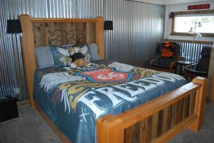 a bedroom with a bed with a dog sitting on it at Cowboy Country Inn in Escalante