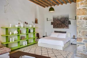 a bedroom with a bed and a green book shelf at Xinara House Old Blacksmiths in Tripótamos