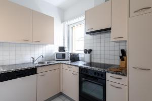 A kitchen or kitchenette at Lido Apartments by Quokka 360 - 5 min from the centre and the Lugano Lido