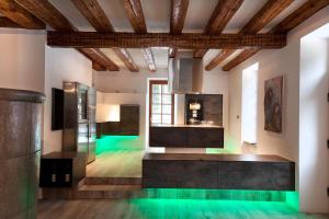 a large kitchen with green lighting in a room at Herrenhaus Schluchsee in Schluchsee
