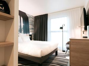 Cama ou camas em um quarto em Novotel Angers Centre Gare