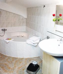 a bathroom with a bath tub and a sink at Ferienwohnung Haus Edith in Laufenburg in Laufenburg