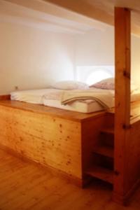 a bed in a room with a wooden bunk bed at Ferienwohnung Haus Edith in Laufenburg in Laufenburg