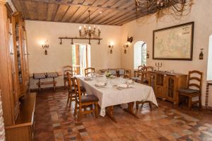 a dining room with a table and chairs at Smuku Muiža in Remte