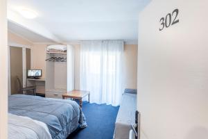 Rúm í herbergi á Hotel Rubino