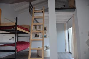 a bunk bed in a room with a ladder at Rollarthouse in Rollamienta