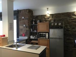 a kitchen with a sink and a refrigerator at Rollarthouse in Rollamienta