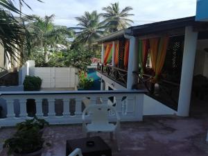 a balcony of a house with a white railing at House Jardin Del Caribe in Las Terrenas