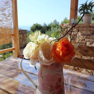 a vase filled with flowers sitting on a table at Greenside Cottage Lumi in Vela Luka +69 photos
