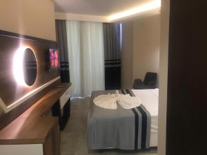 Postel nebo postele na pokoji v ubytování Sette Serenity Hotel