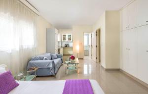 a living room with a blue couch and a table at City Mansion Rhodes in Rhodes Town +26 photos