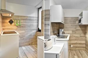 - une cuisine avec des appareils blancs et un mur en bois dans l'établissement Casa Raffaele, à Malcesine