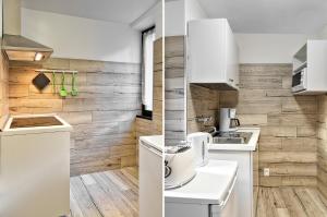 cocina con electrodomésticos blancos y pared de madera en Casa Raffaele, en Malcesine