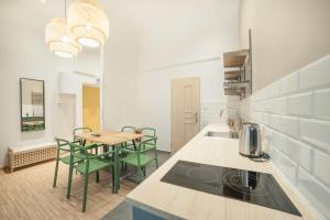 a kitchen with a table and chairs in a room at Dizzy Daisy Hostel in Krakow