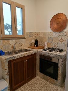 a kitchen with a stove and a sink at La Casa di Pitti in Anacapri