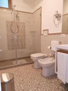 a bathroom with a toilet and a shower and a sink at La Casa di Pitti in Anacapri