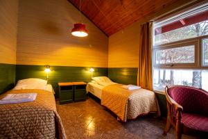 a room with two beds and a window in it at Tysfjord Hotel in Storjord I Tysfjord