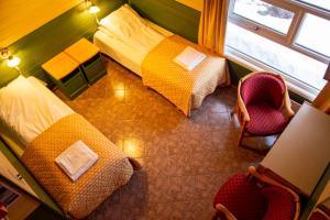 a hotel room with two beds and a window at Tysfjord Hotel in Storjord I Tysfjord