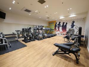a gym with treadmills and cardio equipment in a room at Garden hotel Shiunkaku Higashimatsuyama / Vacation STAY 77481 in Higashimatsuyama