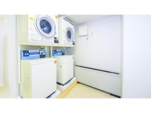 a kitchen with two refrigerators and a microwave at Garden hotel Shiunkaku Higashimatsuyama / Vacation STAY 77481 in Higashimatsuyama