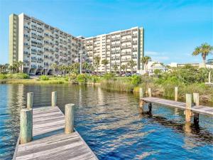 a large apartment building next to a body of water at Pinnacle Port Beach Resort in Panama City Beach
