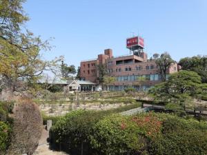 a building with a clock tower on top of it at Garden hotel Shiunkaku Higashimatsuyama / Vacation STAY 77479 in Higashimatsuyama