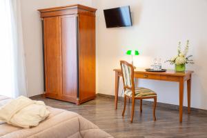 a bedroom with a desk and a table with a chair at Villa Donna Carmela in Pimonte