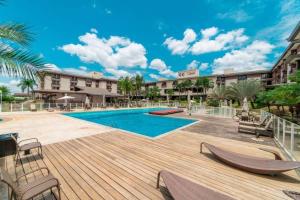a resort with a swimming pool and a wooden deck at Life Resort às margens do lago in Brasília