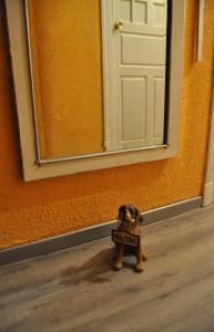a small dog standing in front of a door at Hospedaje Botin in Santander