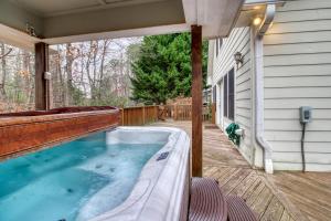 a hot tub on a deck with a house at Alpine Retreat in Helen