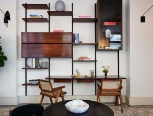 a living room with two chairs and a table at Walker Hotel Tribeca in New York